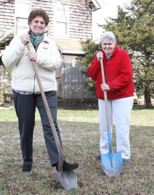 Marie Marole and Carol Wells break ground on the community garden